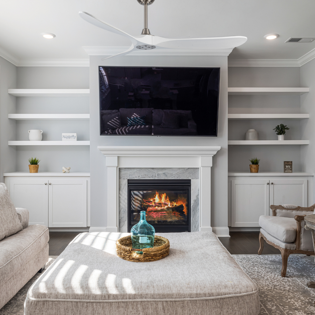 Living room with a fireplace, TV, and decorative items.