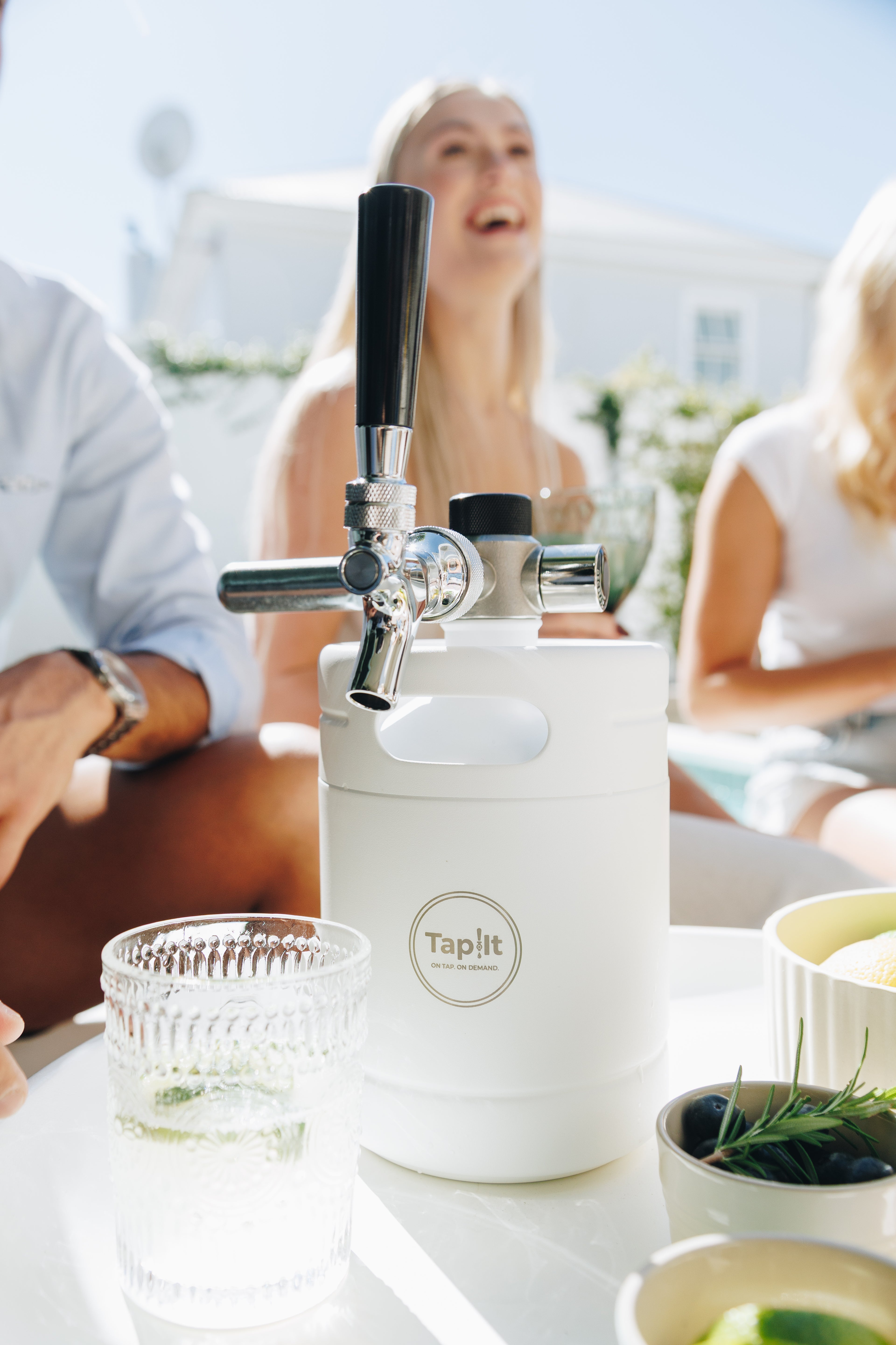 Taplit beer dispenser on a table with people in the background