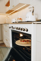 White oven with pizza inside in a modern kitchen
