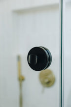 Black door handle on a glass door with a blurred background