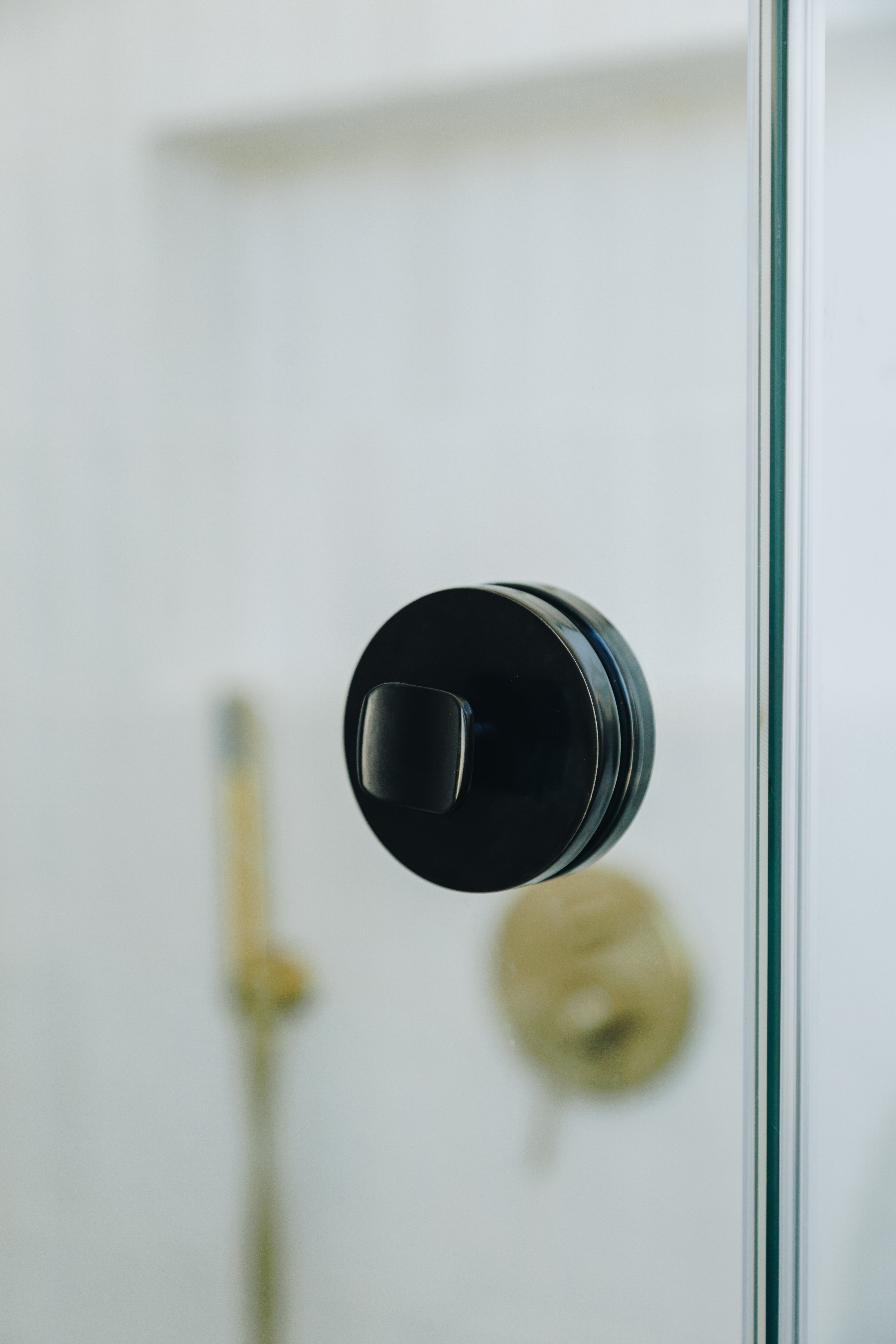 Black door handle on a glass door with a blurred background